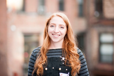 A person smiling at camera
Description automatically generated